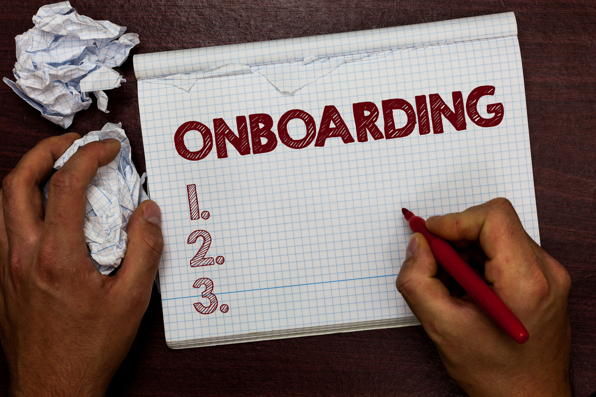 Word writing text Onboarding. Business concept for Action Process of integrating a new employee into an organization Man holding marker notebook page crumpled papers several tries mistakes.